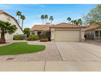 Inviting single-story home with a tile roof, desert landscaping, and a two-car garage at 4031 N Ranier --, Mesa, AZ 85215