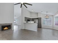 Open-concept living space with a fireplace, tile flooring, and gray accents at 4031 N Ranier --, Mesa, AZ 85215