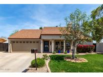 Inviting home exterior showcasing a well-maintained lawn and attractive landscaping, plus a two-car garage at 4525 E Desert View Dr, Phoenix, AZ 85044