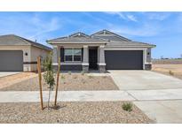Charming single-story home with a gray color palette, a well-kept yard and a two car garage at 46378 W Lander Ln, Maricopa, AZ 85139