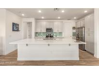 Bright, open kitchen boasts an oversized island, stainless appliances, and modern finishes at 5100 E Rancho Paloma Dr # 2078, Cave Creek, AZ 85331