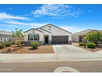 Charming single-story home with a well-manicured lawn and a two-car garage at 5237 W Alta Mesa Ave, Laveen, AZ 85339