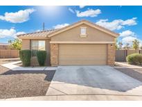 Attached two-car garage featuring stone accents and convenient driveway parking for residents and guests at 6763 W Wethersfield Rd, Peoria, AZ 85381