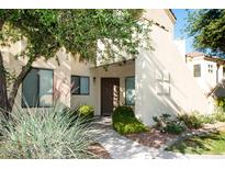 Inviting exterior with lush landscaping, a walkway, and a warm, welcoming facade at 7575 E Indian Bend Rd # 1012, Scottsdale, AZ 85250