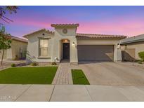 Charming single-story home with well-manicured lawn, beautiful brick driveway, and neutral stucco exterior at 14640 W Dahlia Dr, Surprise, AZ 85379