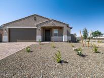 Charming single-story home with a well-maintained gravel yard and a two-car garage, perfect for suburban living at 17809 W Elm St, Goodyear, AZ 85395