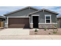 Charming single-story home featuring a brown garage door, stone accents, and a well-maintained front yard at 3582 E Audrey Dr, San Tan Valley, AZ 85143