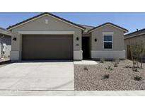 Charming single-story home with neutral stucco, a brown garage door, and low-maintenance desert landscaping at 46395 W Lander Ln, Maricopa, AZ 85139