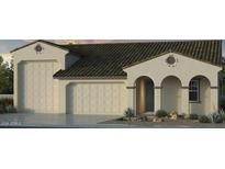 Beige single Gathering home featuring a three car garage, arched entry and neutral desert landscaping at 5210 W Top Hand Trl, Laveen, AZ 85339