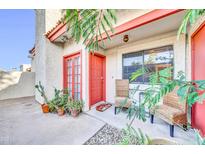 Charming front entrance with red door, desert landscaping, and cozy seating area, perfect for enjoying the outdoors at 633 W Southern Ave # 1131, Tempe, AZ 85282
