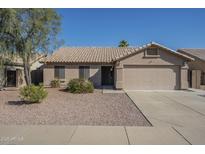 Charming single-story home with a well-maintained front yard and a two-car garage at 9252 W Mountain View Rd, Peoria, AZ 85345