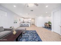 Open-concept living and dining areas with modern decor, seamlessly connected to a bright kitchen and comfortable seating at 17244 W West Wind Dr, Surprise, AZ 85387