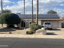 Charming single-story home featuring solar panels and a well-manicured front yard at 2324 E Cortez St, Phoenix, AZ 85028