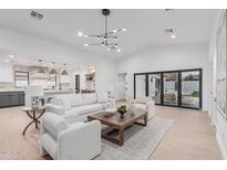 Inviting living room with open kitchen view and access to the backyard at 2546 E Roma Ave, Phoenix, AZ 85016