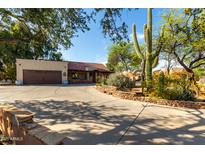 Charming single-story home featuring desert landscaping, a large driveway, and a two-car garage at 5616 E Desert Vista Trl, Cave Creek, AZ 85331