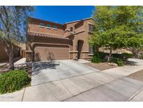 Inviting two-story home featuring a two-car garage, landscaped yard, and charming desert landscaping at 6746 W Wethersfield Rd, Peoria, AZ 85381