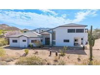 Desert home featuring white stucco, a tile roof, and arid landscaping with mature cactus at 3215 N 83Rd St, Mesa, AZ 85207