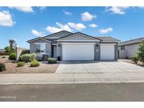 Charming single-story home with three-car garage and low-maintenance desert landscaping at 35733 W Santa Monica Ave, Maricopa, AZ 85138