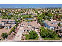 Expansive estate featuring a private pool, lush landscaping, a circular driveway, and a three-car garage at 3356 E Vallejo Ct, Gilbert, AZ 85298