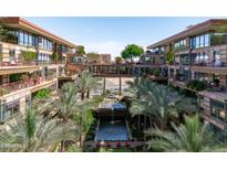 Stunning courtyard view showcasing lush landscaping and a relaxing water feature, connecting modern residences at 7131 E Rancho Vista Dr # 1008, Scottsdale, AZ 85251