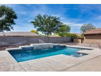 Sparkling backyard pool featuring a stone water feature, concrete surround, and a charming rubber ducky at 22616 S 194Th St, Queen Creek, AZ 85142