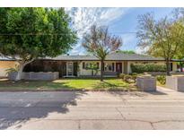 Well-maintained single-story home showcasing lush landscaping, mature trees, and inviting curb appeal at 2938 N 18Th Ave, Phoenix, AZ 85015