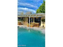 Backyard pool and covered patio area perfect for outdoor dining and entertaining at 2938 N 18Th Ave, Phoenix, AZ 85015