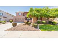 Beautiful two-story home featuring a well-maintained lawn, mature landscaping, and a two-car garage at 747 E Charlevoix Ave, Gilbert, AZ 85297