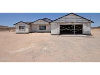 New construction shows exterior with unfinished siding and visible framing, set against a desert landscape at 1664 N 431St Ave, Tonopah, AZ 85354