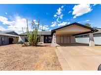 Charming single-story home with desert landscaping and a covered two-car carport at 3008 W Michigan Ave, Phoenix, AZ 85053