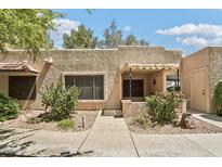 Charming single-story home featuring desert landscaping and a welcoming covered front porch at 14300 W Bell Rd # 145, Surprise, AZ 85374