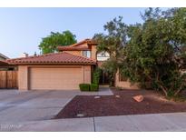 Charming two-story home featuring a well-maintained yard, terracotta roof, and an attached two-car garage at 2239 S Cottonwood --, Mesa, AZ 85202