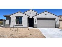 Charming single-story home with a two-car garage and low maintenance front yard at 23328 W Miami St, Buckeye, AZ 85326