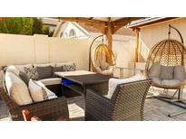 Cozy covered patio area with comfortable seating and stylish hanging chairs at 3017 E Bluefield Ave, Phoenix, AZ 85032