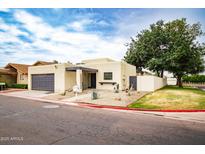 Charming home showcasing desert landscaping, an attached garage, and a well-manicured lawn at 3029 W Sierra St, Phoenix, AZ 85029