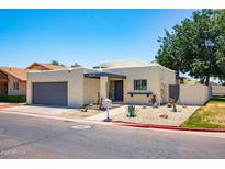 Charming single story home featuring desert landscaping, private front courtyard, and a gray two car garage at 3029 W Sierra St, Phoenix, AZ 85029