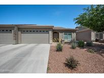 Charming single-story home featuring a three-car garage and desert landscaping in front at 3117 S Signal Butte Rd # 484, Mesa, AZ 85212