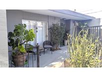 Cozy patio with seating area, potted plants, gray pavers, and sliding glass doors at 3650 E Montecito Ave # 4, Phoenix, AZ 85018