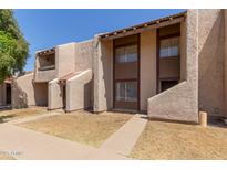 View of multiple townhomes, highlighting the architectural design, tiled roofs, and landscaped surroundings at 5742 N 43Rd Dr, Glendale, AZ 85301