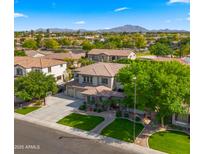 Stunning aerial view of a two-story home featuring a three-car garage and lush landscaping at 643 E Hopkins Rd, Gilbert, AZ 85295