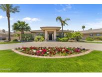 Charming home features a circular driveway with beautiful flower bed and an inviting front entrance at 7272 N 71St St, Paradise Valley, AZ 85253