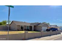 Charming single-story home featuring a low-walled front yard and a two-car garage at 7901 W Tuckey Ln, Glendale, AZ 85303