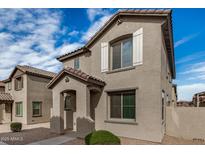Charming two-story home features a welcoming entryway and neutral stucco, complemented by a tiled roof at 829 E Agua Fria Ln, Avondale, AZ 85323