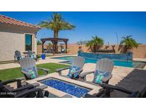Inviting pool area with lounge chairs, pergola, and lush landscaping at 21623 S 223Rd Pl, Queen Creek, AZ 85142