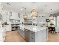 Elegant kitchen featuring a large island, stainless steel appliances, and stylish pendant lighting at 2625 N 24Th St # 13, Mesa, AZ 85213