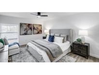 Beautifully staged main bedroom with stylish furnishings, decor, and a ceiling fan at 3416 N 44Th St # 51, Phoenix, AZ 85018