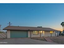 Charming single-story home with a well-maintained front yard and a two-car garage at 10713 E Oasis Dr, Mesa, AZ 85208