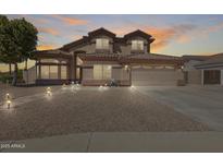 Beautiful two-story home featuring a tile roof, desert landscaping, and path lighting at 1266 S Harrington St, Gilbert, AZ 85233