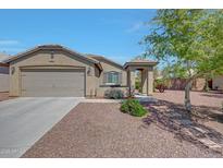 Inviting single-story home featuring a low maintenance yard, covered porch entry, and attached two car garage at 18590 W Vogel Ave, Goodyear, AZ 85338