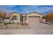 Inviting single-story home featuring a brick driveway, two-car garage, and low-maintenance landscaping at 23038 E Twilight Dr, Queen Creek, AZ 85142